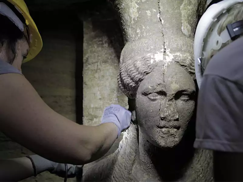Female statue being excavated